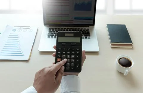 Close up businessman using calculator on documents Unrecognizable finance  us Stock Photos