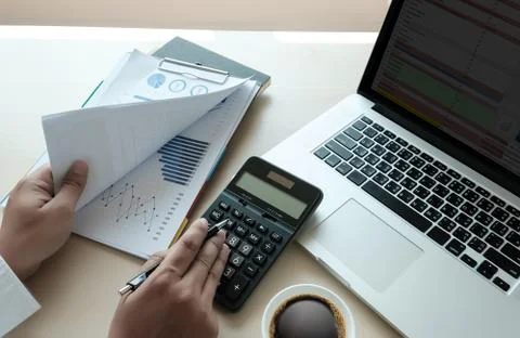 Close up businessman using calculator on documents Unrecognizable finance  us Stock Photos