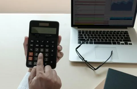Close up businessman using calculator on documents Unrecognizable finance  us Stock Photos