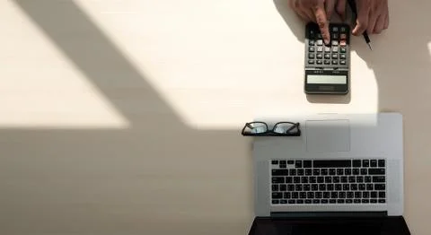 Close up businessman using calculator on documents Unrecognizable finance  us Stock Photos