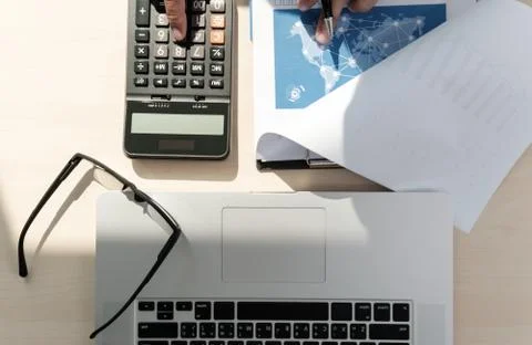 Close up businessman using calculator on documents Unrecognizable finance  us Stock Photos