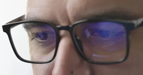 Close-up businessman using computer at office, stock market diagram reflecting Stock Footage 274216623