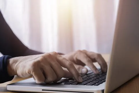 Close up businessman using laptop computer at home. Close up male hands typin Stock Photos