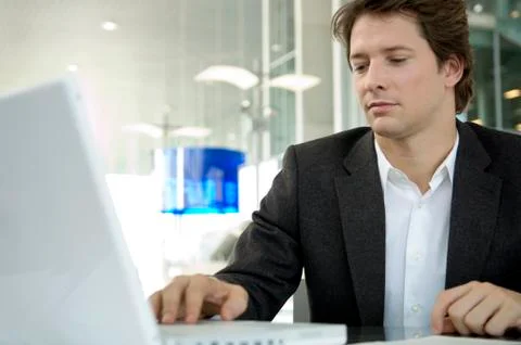 Close-up of a businessman using a laptop in an office Stock Photos