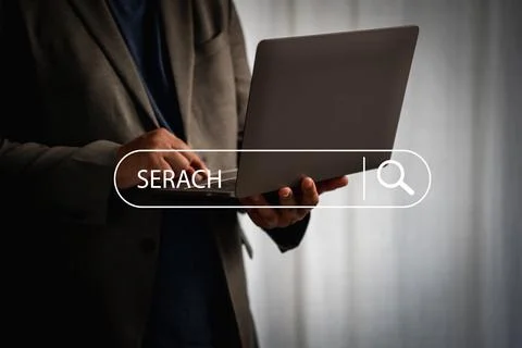 Close-up of businessman using laptop with virtual search bar, symbolizing j.. Stock Photos