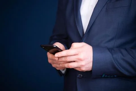 Close up of a businessman using mobile smart phone Stock Photos