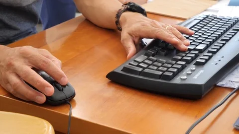 Close up of a businessman using old style mouse and keyboard office desk at work Stock Footage 118004230