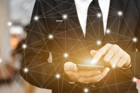Close up of Businessman using smartphone with icon network. Man hand holding  Stock Photos