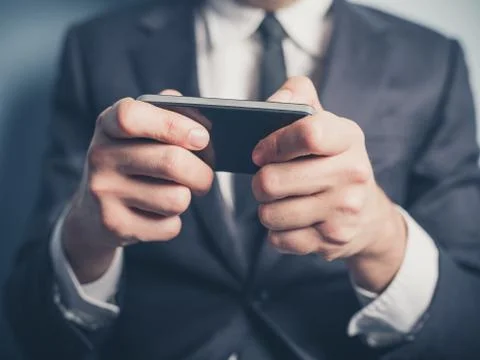 Close up on businessman using smartphone Stock Photos