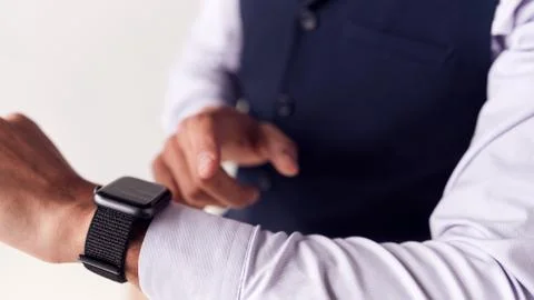 Close Up Of Businessman Wearing Suit Looking At Smart Watch Stock Photos