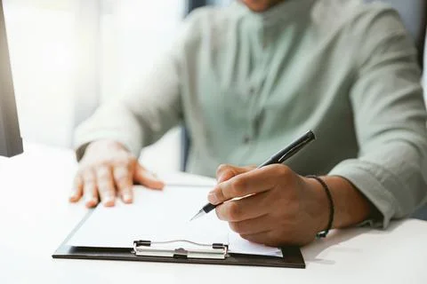Close up of businessman working with documents while sitting in office Stock Photos