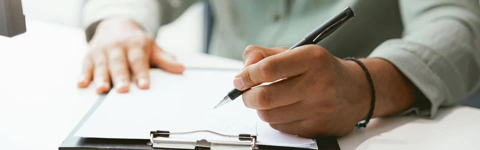 Close up of businessman working with documents while sitting in office Stock Photos
