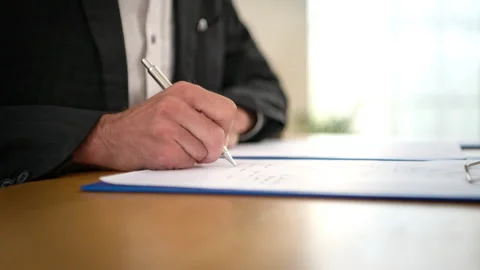 Close-up of businessman write documents at office desk with pen Video stock 341110682