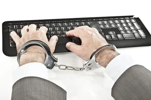 Close up of businessman's hand cuffed while cyber crime Stock Photos