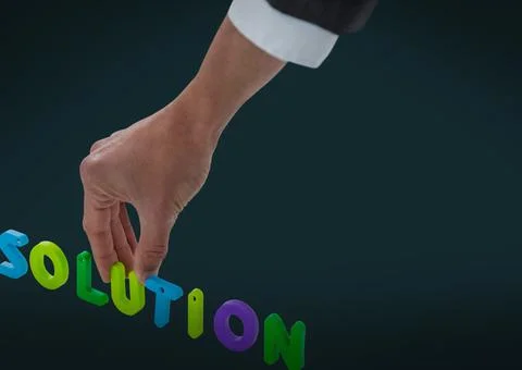 Close of businessman's hand making solution text against copy space on green Foto stock