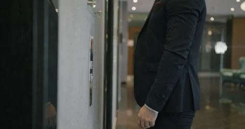 Close-up of businessman's hand pressing elevator button in hotel lobby while man Video stock 244316267