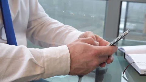 Close up on businessman's hands browsing smartphone  Video stock 73421960