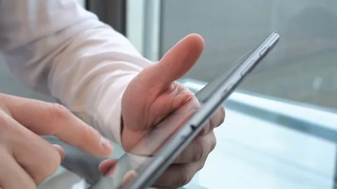 Close up on businessman's hands browsing tablet, dolly shot backward  Video stock 73421900