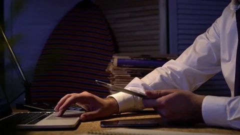Close up of businessman's hands. He is working with his tablet at night office. Stock Footage 70241167