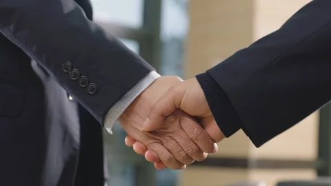 Close-up of businessmen shaking hand &amp; greeting in office Stock Footage 123789189