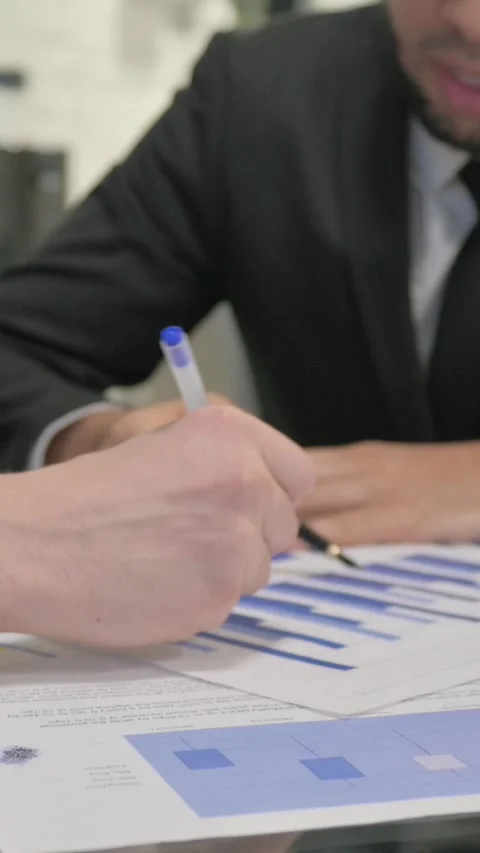 Close up of Businessmen Working on Documents, vertical video 動画素材 325568484