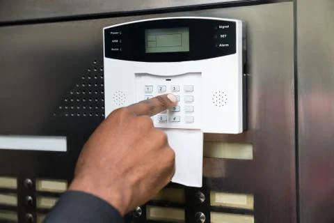 Close-up Of Businessperson's Hand Entering Code In Security System Stock Photos