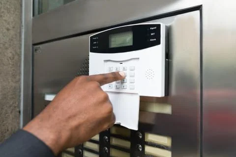 Close-up Of Businessperson's Hand Entering Code In Security System Stock Photos