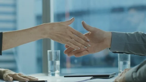 Close-up of the Businesswoman and Businessman Closing the Deal and Shaking Hands Stock Footage