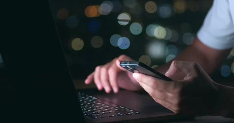 Close up busy business man using touchpad on laptop and scrolling his smartphone Stock Footage 244511374