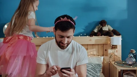 Close-up busy sociable man using a smartphone sitting on bed. Happy joyful Stock Footage 112261677