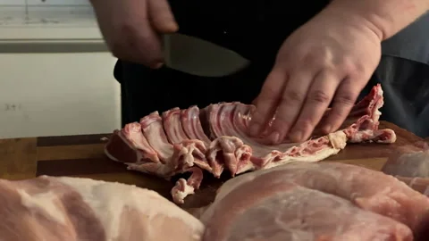Close-up of a butcher cutting lamb ribs  in a shop Stock Footage 308239498