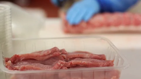 Close-up Of A Butcher Worker Cutting Meat Stock Footage 127885199