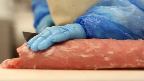 Close-up Of A Butcher Worker Cutting Meat Stock-Footage 127885207