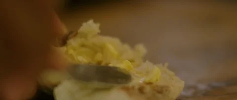 Close up of butter being spread onto bread Stock Footage 106212582