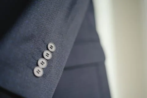 Close-up of a button on a blue business jacket Stock Photos