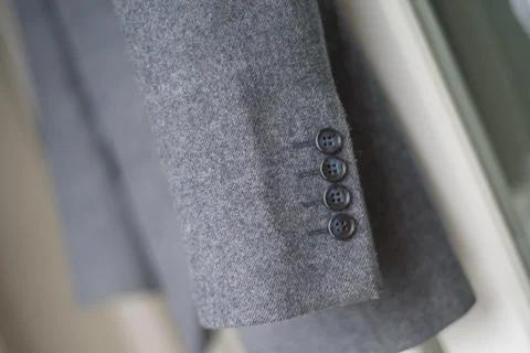 Close-up of a button on a blue business jacket Photos