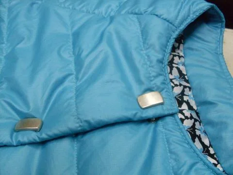 Close up of button clasp on blue coat Stock Photos