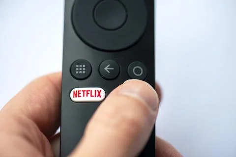 Close-up of button with Netflix logotype on a TV remote in Berlin Stock Photos