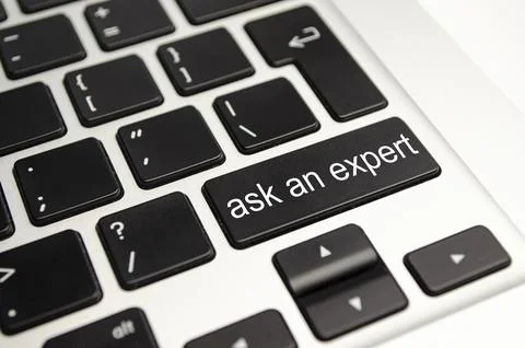 Close up button with the words ask an Expert, on a black keyboard. Creative.. Stock Photos