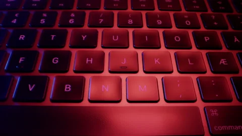 Close-up of Buttons of Black Laptop Keyboard in Colorful Lights Stock Footage 213898484