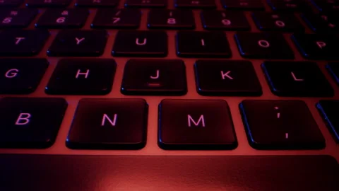 Close-up of Buttons of Black Laptop Keyboard in Colorful Lights Stock Footage 213899602