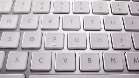 Close-up of Buttons of Wireless White and Silver Keyboard Video stock 213896519