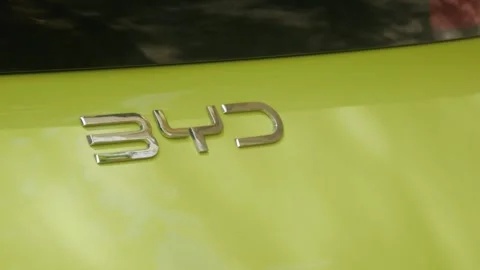 Close-Up of BYD Logo on Green Electric Vehicle Stock Footage 340086607