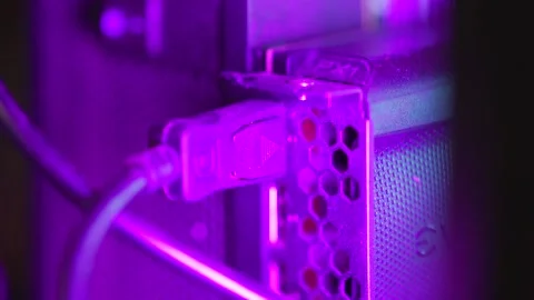 Close-Up of Cable Plugged into Metal Component with Purple Lighting | HLG Stock Footage 303095045
