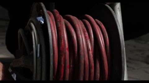Close-up of the cable pulled from the extension drum of the cable reel, Male Video stock 190022770
