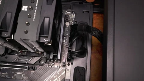 Close-up of cables connected to a motherboard in a PC setup. Ideal for tech Stock Footage 301637109