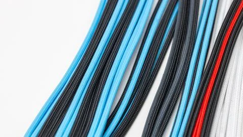 Close-up of cables in a system unit, blue computer wiring in a braided sheath Stock Photos