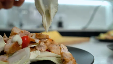 Close-up of Caesar Salad. Appetizing. Chef Finishes Cooking. Spoon Pour Sauce Stock Footage 147237210