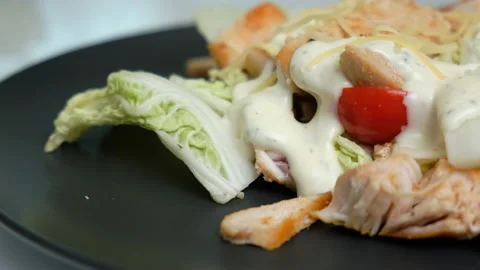 Close-up of Caesar Salad. Fried Chicken Breast until Crispy. Tomatoes. Delicious Stock Footage 147237258