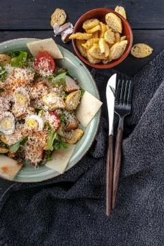 Close-Up Caesar salad with quail egg, fried chicken, parmesan cheese and crou Stock Photos